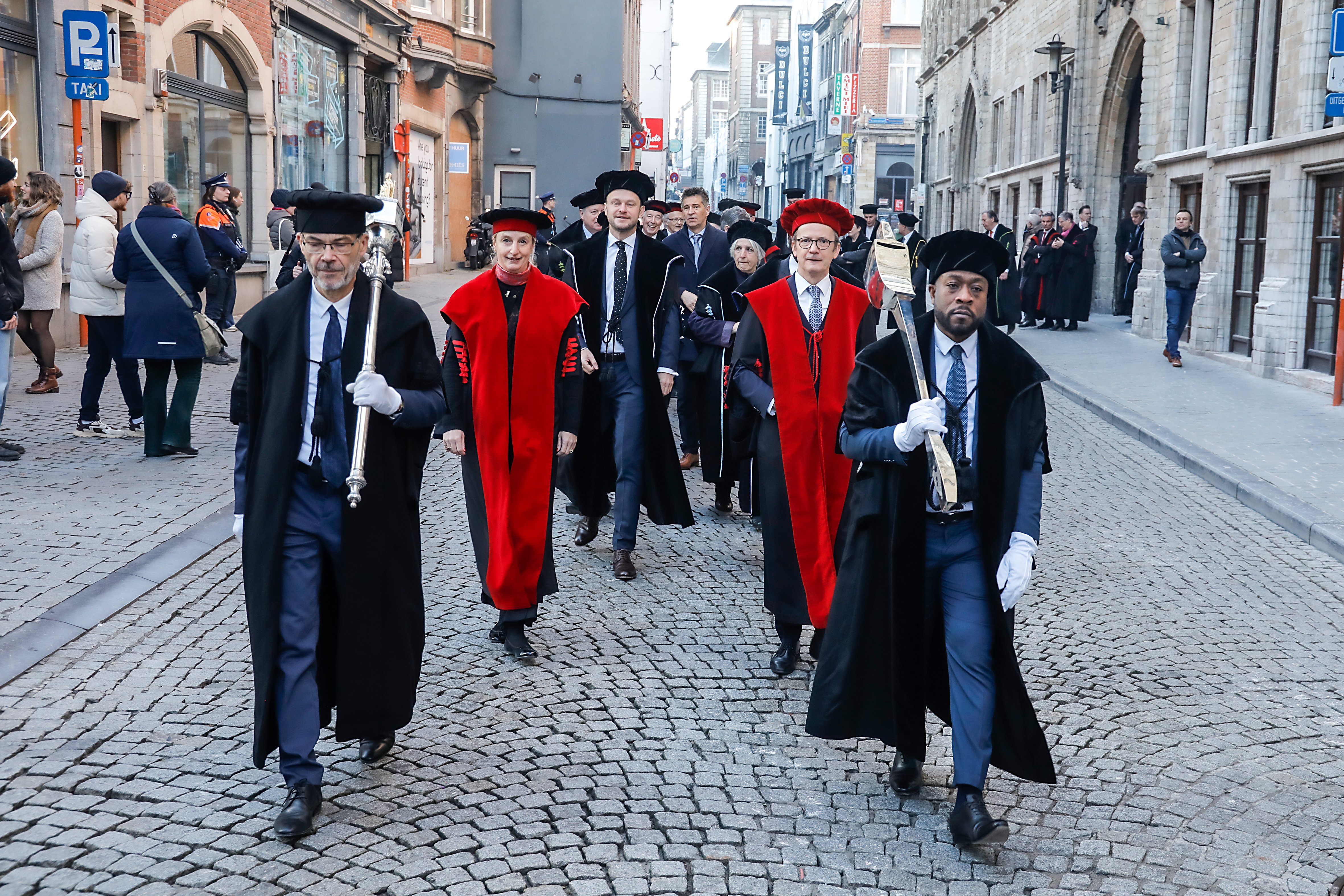 A photo of Max Roser and others marching through town as part of the ceremony for receiving an honorary doctorate from KU Leuven and UCLouvain in Belgium. The photo is copyright KU Leuven - Rob Stevens.